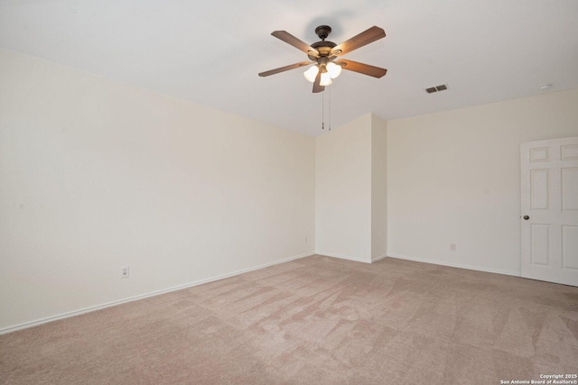 empty room with light colored carpet and ceiling fan