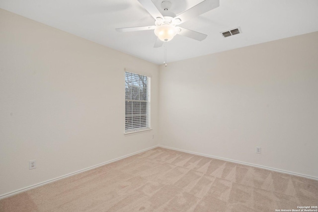 carpeted spare room featuring ceiling fan