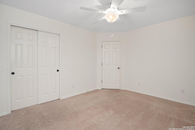 unfurnished bedroom featuring light carpet, a closet, and ceiling fan