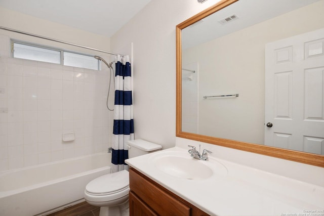 full bathroom featuring vanity, toilet, and shower / tub combo