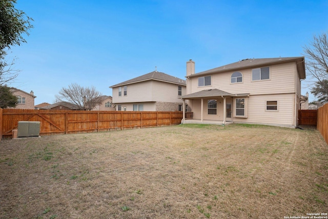 back of property featuring a yard and a patio