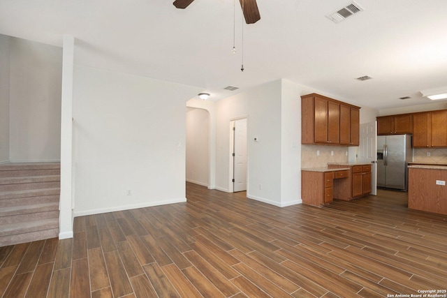 kitchen featuring tasteful backsplash, stainless steel fridge with ice dispenser, dark hardwood / wood-style floors, and ceiling fan