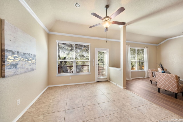 interior space with crown molding, light tile patterned flooring, and vaulted ceiling