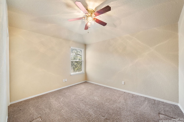 empty room with carpet floors, ceiling fan, and vaulted ceiling