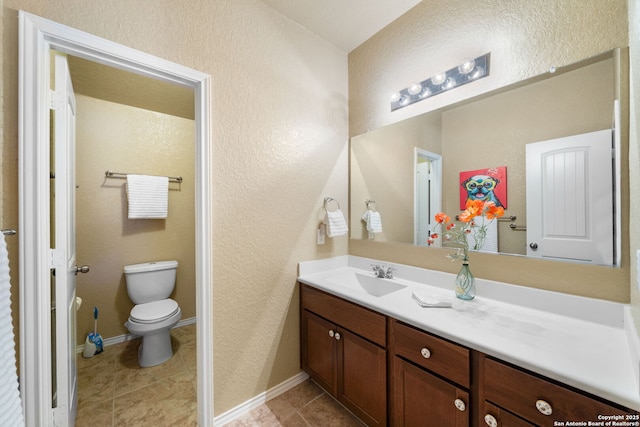 bathroom with vanity, toilet, and tile patterned flooring