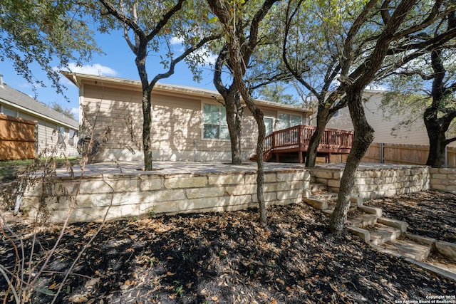 back of house with a wooden deck