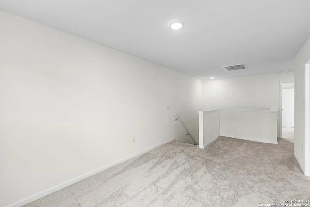 basement featuring light carpet