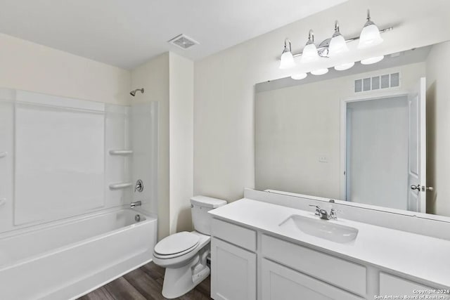 full bathroom with vanity, hardwood / wood-style flooring, shower / washtub combination, and toilet