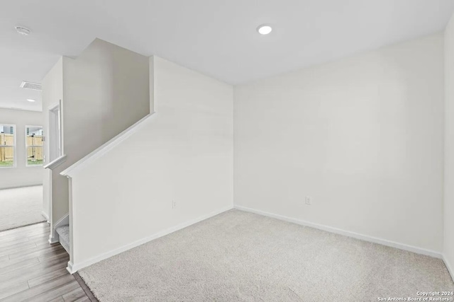 empty room with light colored carpet