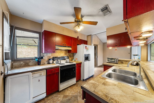 kitchen featuring lofted ceiling, sink, white appliances, ceiling fan, and decorative backsplash