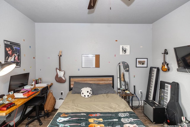 bedroom with dark hardwood / wood-style floors and ceiling fan