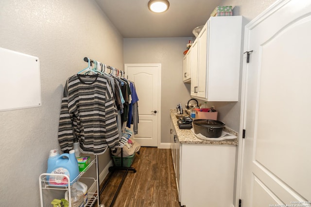 laundry area with dark hardwood / wood-style flooring