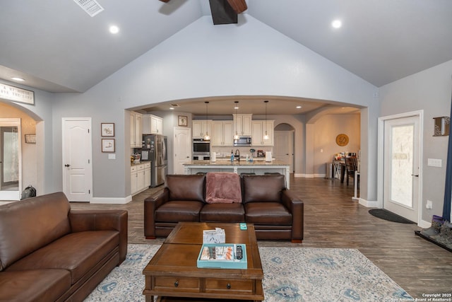 living room with ceiling fan, high vaulted ceiling, and hardwood / wood-style floors