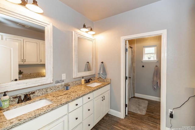 bathroom with vanity and hardwood / wood-style flooring