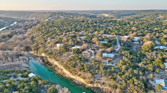 aerial view at dusk featuring a water view