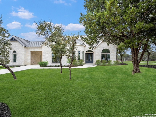 view of front facade featuring a front yard and french doors