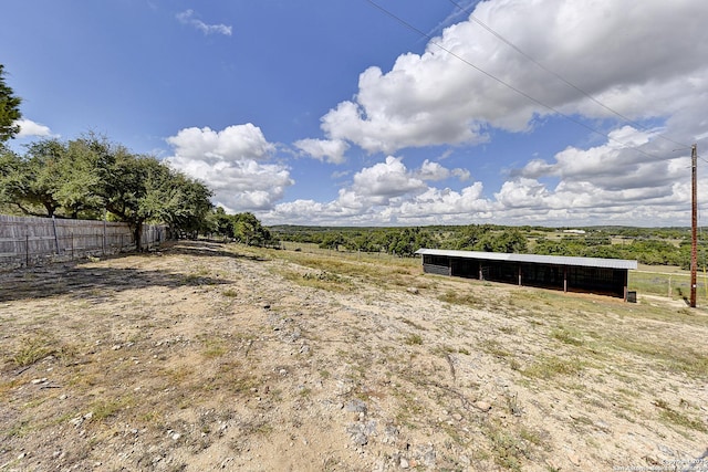 view of yard with an outdoor structure and a rural view