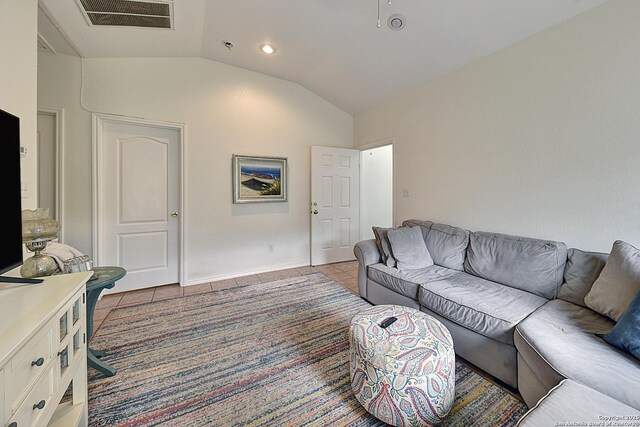 living room with lofted ceiling and light tile patterned floors