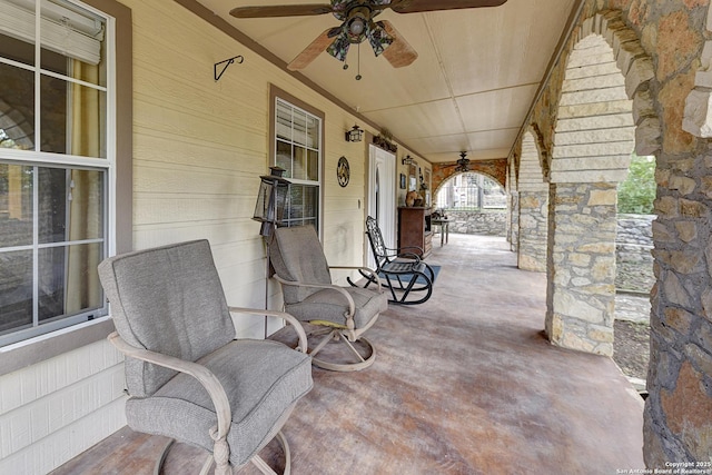 view of patio with ceiling fan and a porch