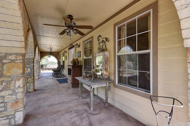 view of patio / terrace with ceiling fan and a porch