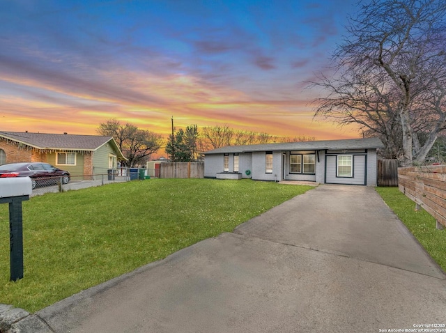 single story home with a lawn