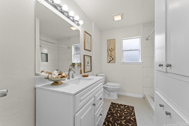 bathroom with tiled shower, tile patterned floors, toilet, and vanity