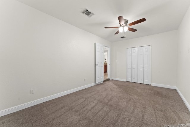 unfurnished bedroom with carpet flooring, ceiling fan, and a closet