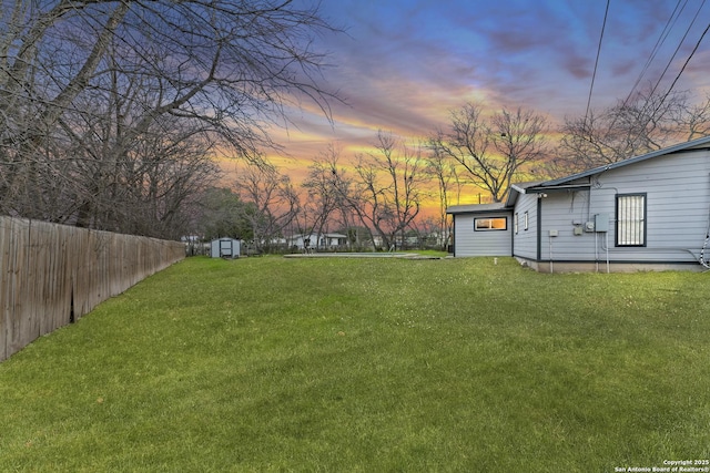 yard at dusk with a storage unit