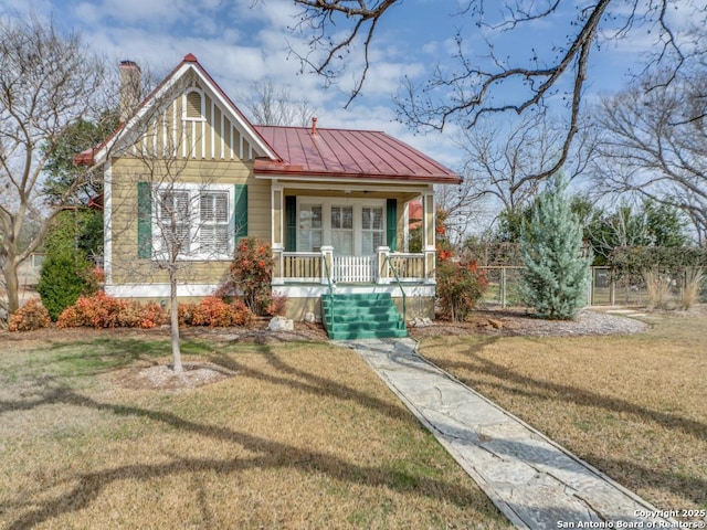 view of front of home with a porch and a front lawn