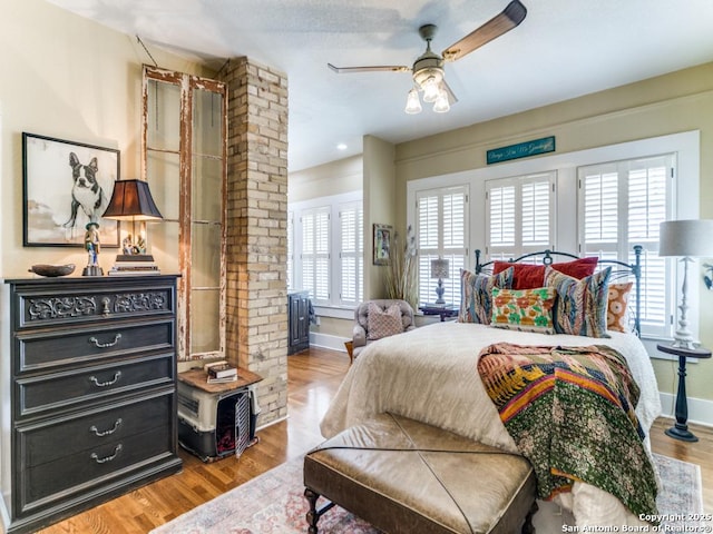 bedroom with ceiling fan, light hardwood / wood-style floors, and decorative columns