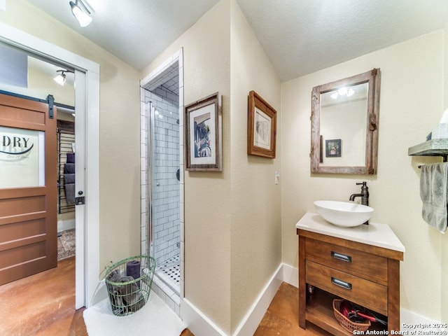 bathroom featuring vanity, an enclosed shower, and concrete floors