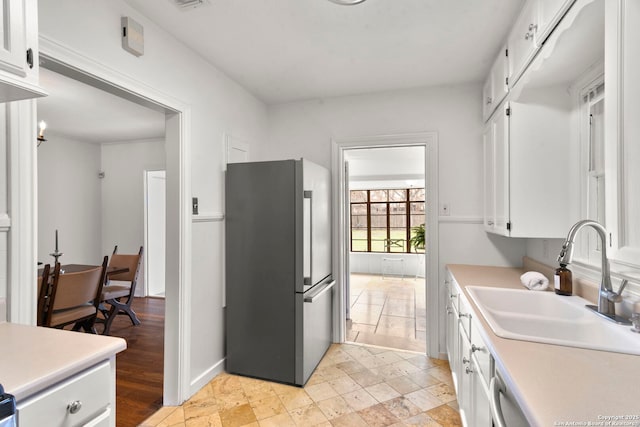 kitchen featuring sink, stainless steel appliances, and white cabinets