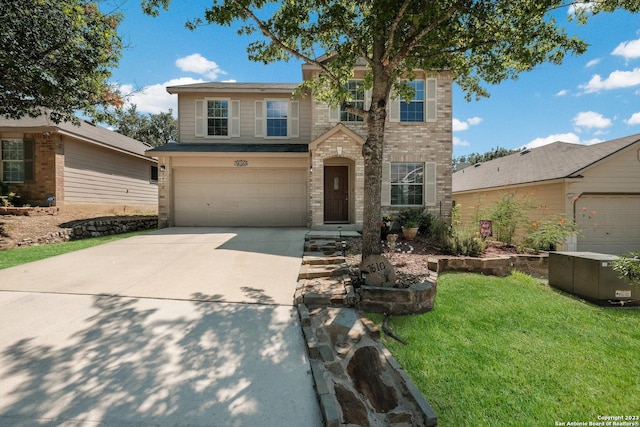 view of front of house featuring a garage and a front lawn