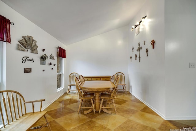 dining area with vaulted ceiling