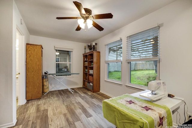 home office with wood-type flooring and ceiling fan