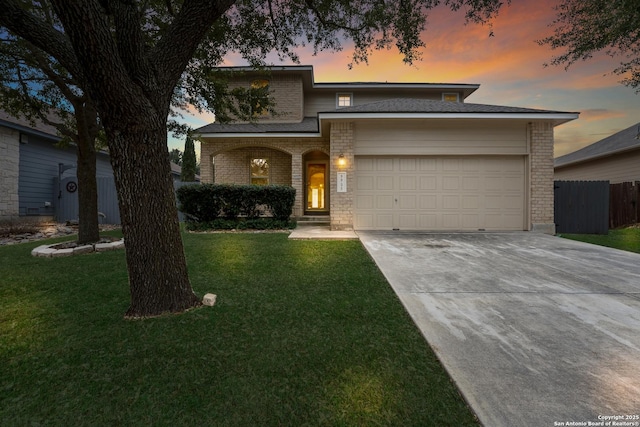 view of front of house with a garage and a yard