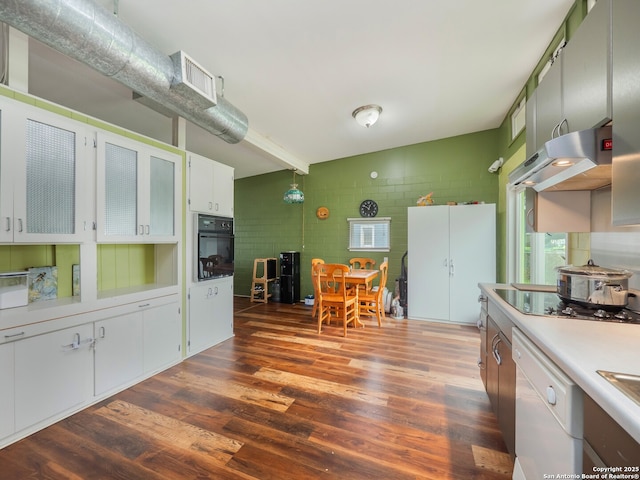 kitchen with white cabinetry, exhaust hood, dark hardwood / wood-style flooring, and black appliances