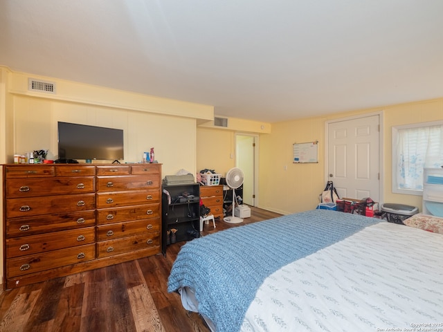 bedroom with dark hardwood / wood-style flooring