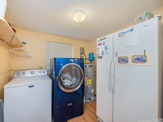 washroom with electric water heater, independent washer and dryer, and light hardwood / wood-style flooring