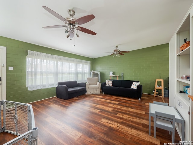 living room featuring brick wall and dark hardwood / wood-style flooring