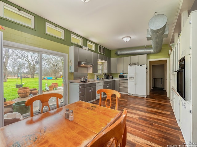 dining space with dark hardwood / wood-style floors