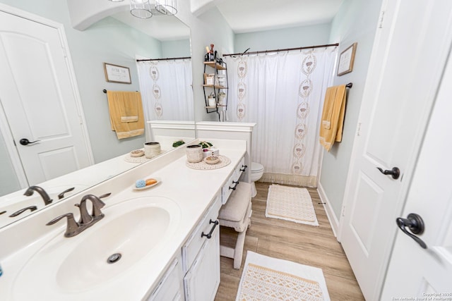 bathroom with vanity, hardwood / wood-style flooring, and toilet