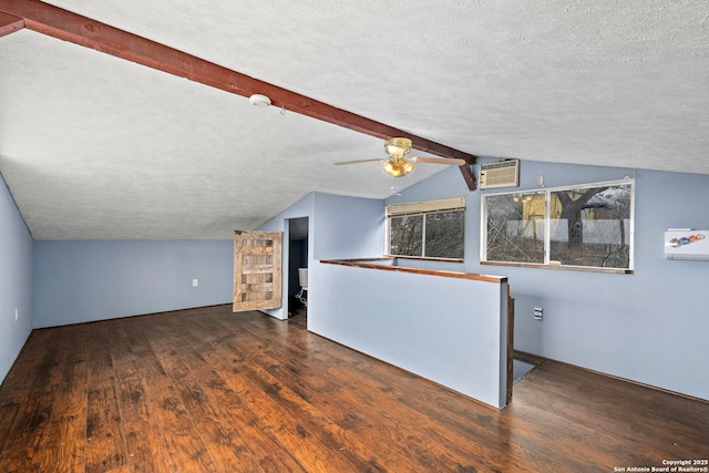 interior space featuring ceiling fan, dark hardwood / wood-style flooring, a textured ceiling, and vaulted ceiling with beams