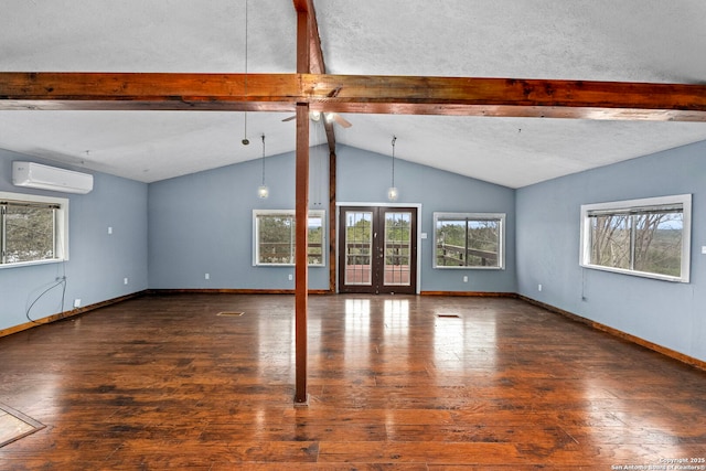 unfurnished living room featuring dark hardwood / wood-style floors, lofted ceiling with beams, french doors, and a wall mounted AC