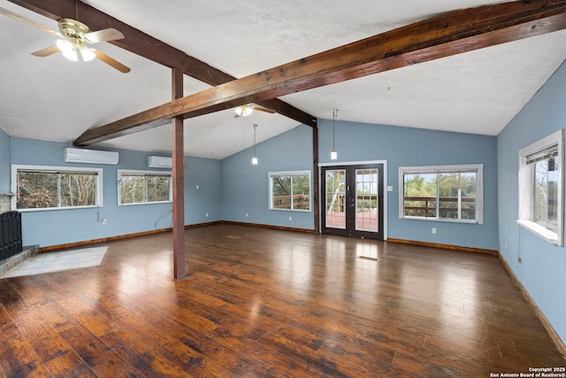 unfurnished living room featuring an AC wall unit, dark wood-type flooring, beam ceiling, and french doors