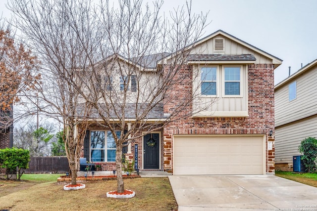 view of front of property with a garage, central AC, and a front lawn