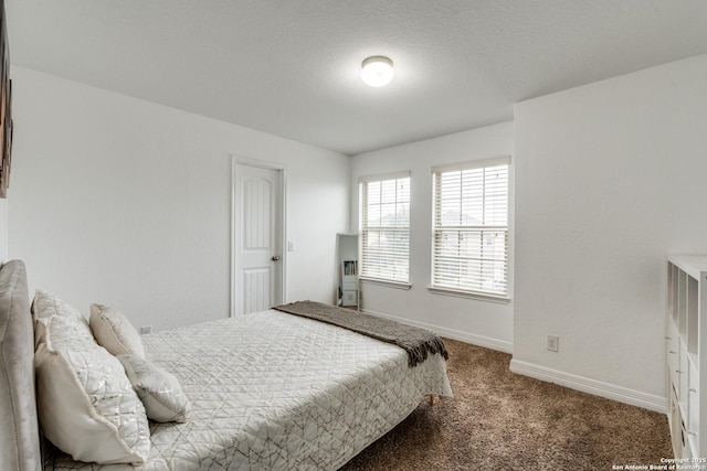 bedroom featuring carpet floors and a textured ceiling