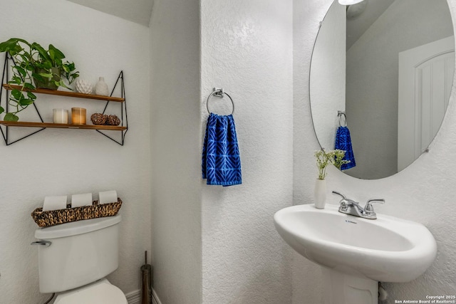 bathroom with toilet and sink