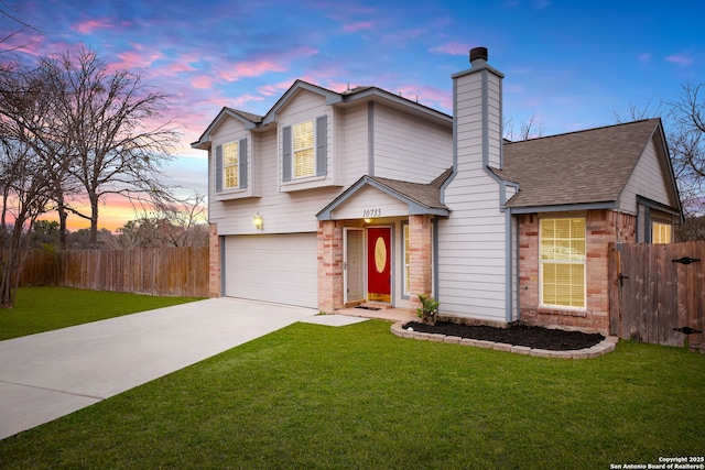 view of front of home featuring a garage and a yard