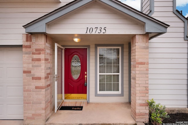 view of exterior entry featuring a garage